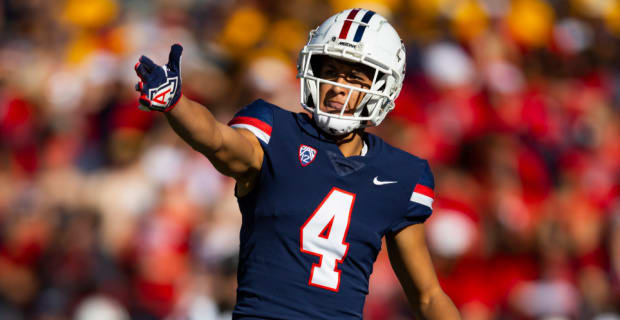 Arizona Wildcats wide receiver Tetairoa McMillan celebrates catching a pass during a college football game.